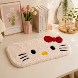 Hand tufted Hello Kitty style multicolor wrist rest placed on a clean vanity desk beside candles, flowers, books, makeup brushes, coffee, and decor items.